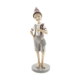 Vintage stílusú, tarisznyát viselő Pinokkió-figura.